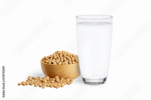 Glass of soy milk and soybeans in wooden bowl isolated on white background.