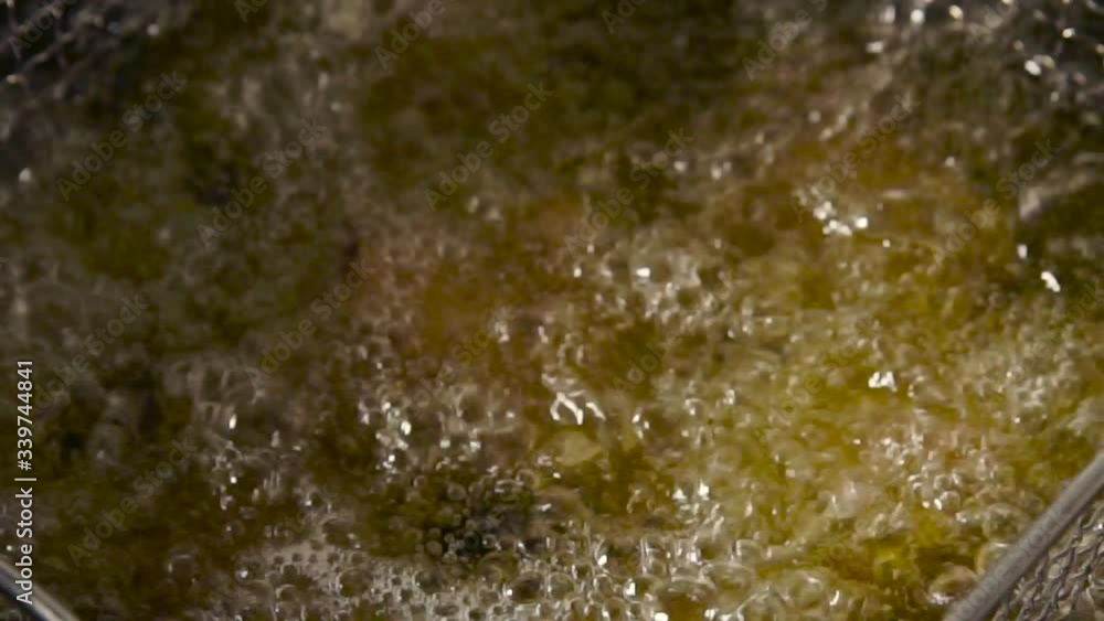 Process of cooking chicken Buffalo wings in the deep fryer Process of cooking chicken Buffalo wings in the deep fryer