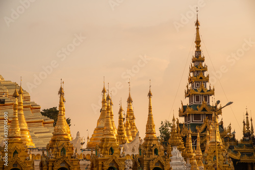 Group of stupa in area of Shwedagon pagoda is Yangon's most famous landmark in Myanmar at sunset. Shwedagon Pagoda enshrines strands of Buddha's hair and other holy relics. © boyloso