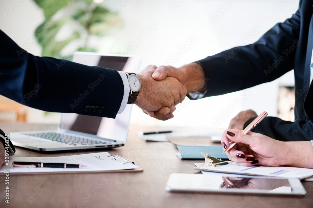 Business people shaking hands together Business people shaking hands together