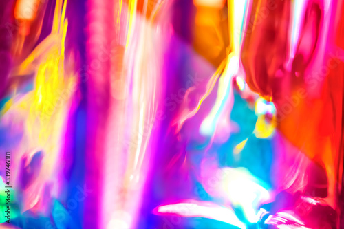 Abstract vivid wallpaper of holographic vertical lens flare neon lights with spectrum psychedelic saturated neon colors and shiny glowing reflections