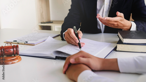 Justice lawyer meeting with contract papers and Judge gavel on tabel in courtroom. Attorney working in courtroom. Justice and law, attorney, court judge concept.