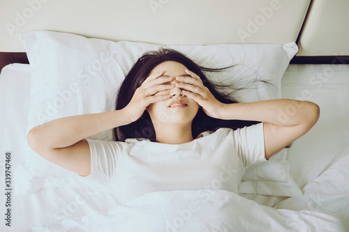 Sleepy woman waking up and rubbing her eyes. Young woman can not sleep.