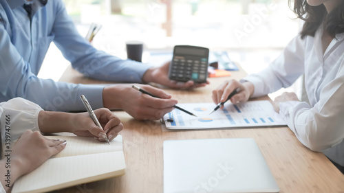 Bilde på lerret Business man supervising and secretary to execute business plan and consultant analyzing company annual financial report balance sheet statement working with documents graphs