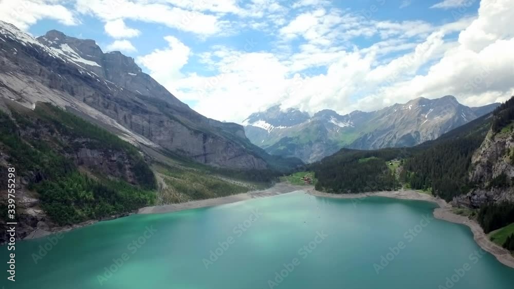 Blue Lake between Mountain Alps in Switzerland shot with flying Aerial Drone through Hills Blue Lake between Mountain Alps in Switzerland shot with flying Aerial Drone through Hills