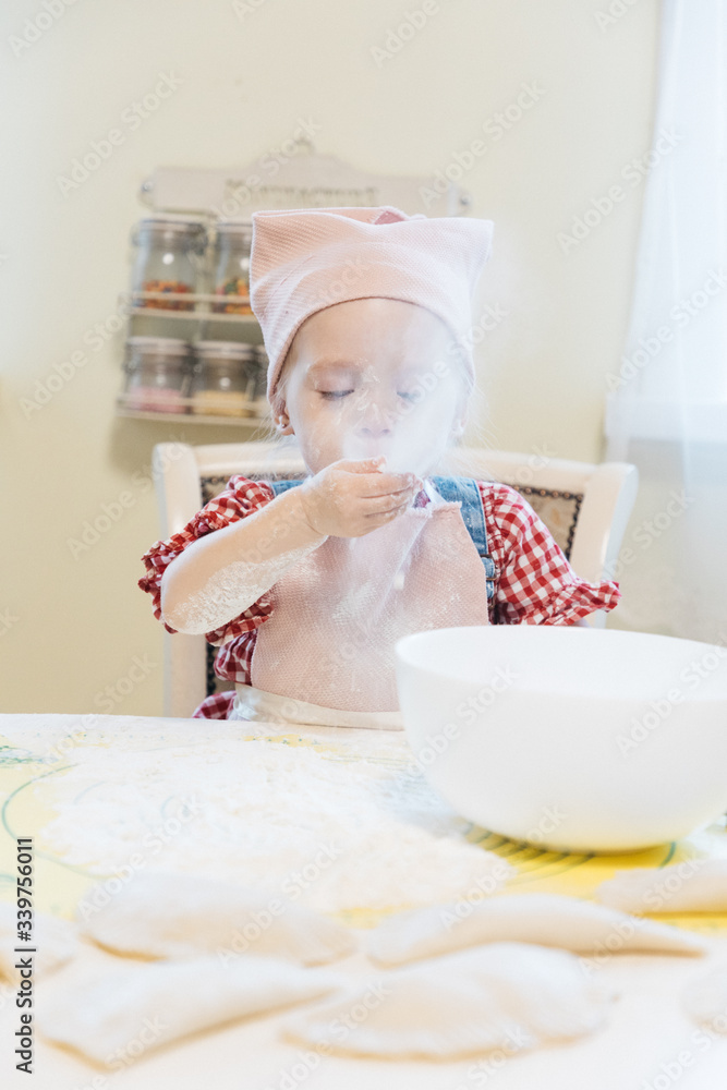 Little girl baking in the kitchen at home Little girl baking in the kitchen at home