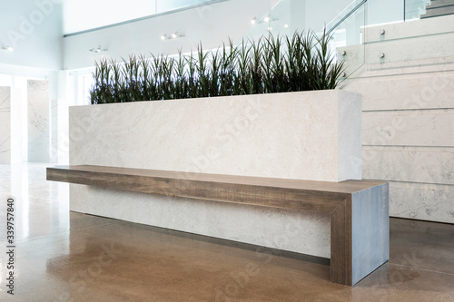 A modern beautiful custom planter bench made with stonelike and woodlike porcelain photo