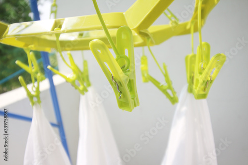 Clothes peg with clean clothes outdoors on laundry day