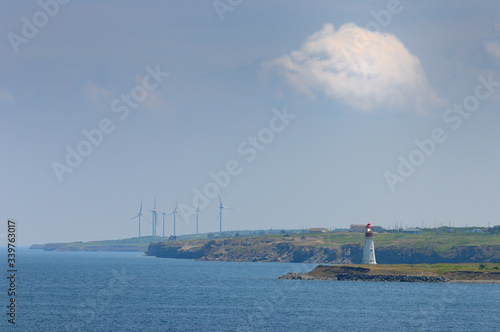 Fototapeta Low Point lighthouse with New Waterford and Lingan wind turbines on Cape Breton
