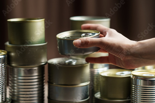 Woman hand with group of Aluminium canned food.