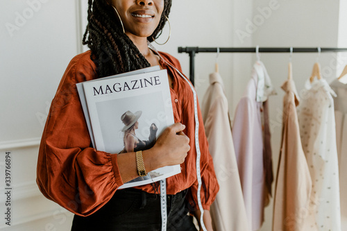 Fashion designer holding a magazine photo