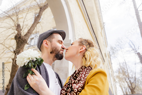 a couple of hipsters and beauties in love walk on a date in the spring city, a young stylish couple