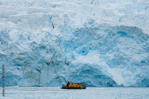 Boat in front of Giant Iceberg