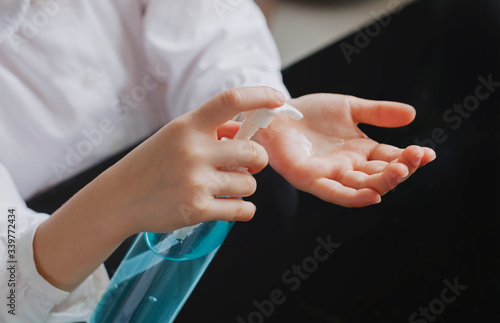 Little girl washing hands with alcohol gel. Hygiene concept. prevent the spread of germs and bacteria and avoid infections corona virus. Clean hands with alcohol gel. Close up.
