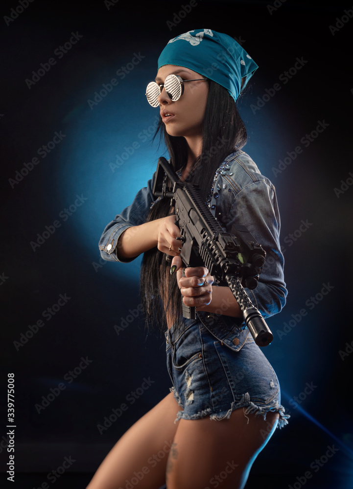 a girl in a DENIM jacket with an AUTOMATIC RIFLE