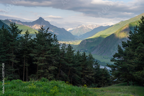 Summer season in Kazbegi valley surrounded by Caucasus mountains range in Georgia