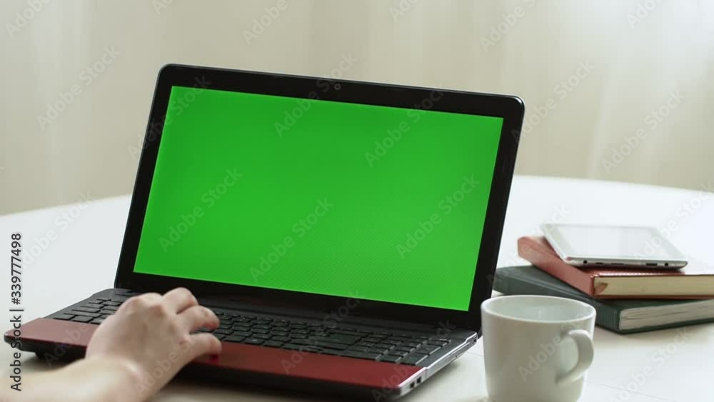 Closeup woman sitting table notebook female hands keyboarding laptop using texting pointing networking green screen chroma key chromakey keyboard white device working message student businesswoman Closeup woman sitting table notebook female hands keyboarding laptop using texting pointing networking green screen chroma key chromakey keyboard white device working message student businesswoman