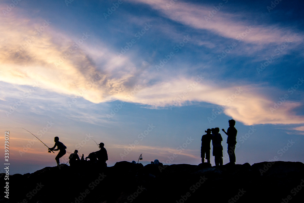 silhouette of a group of people on a beach