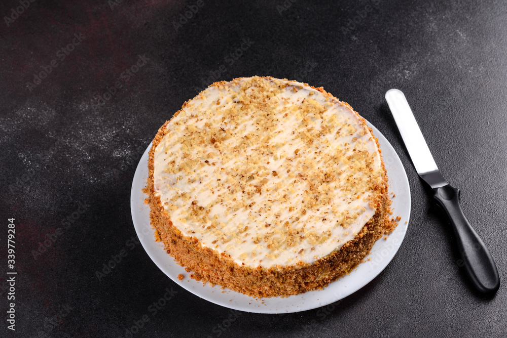 Fresh delicious carrot cake with cream on a dark background