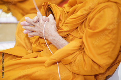 Buddhist monk's hand Is in the ceremony