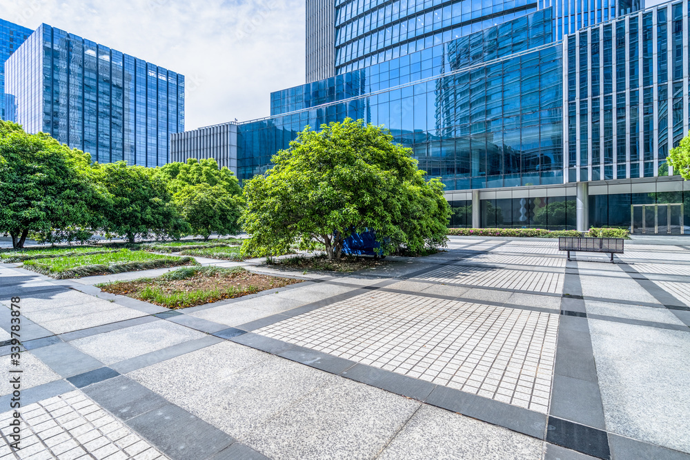 empty pavement and modern buildings in city.