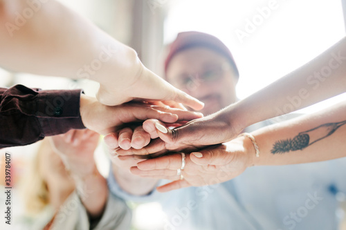 Diverse startup business team stacking hands