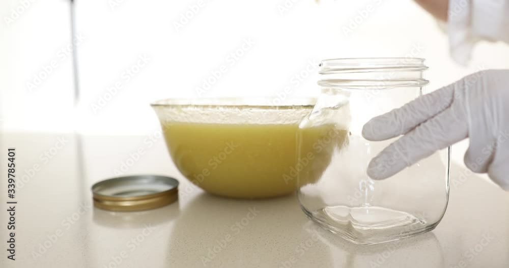 Putting ground pear and ginger into glass jar Putting ground pear and ginger into glass jar