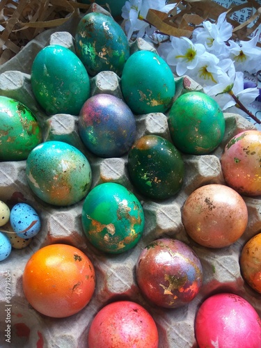 Colorful painted easter eggs with green leaves and decor