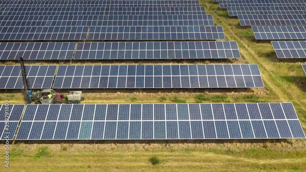 Solar Farm, Machinery And Man Cleaning Panels, Drone Shot, Truck Left Solar Farm, Machinery And Man Cleaning Panels, Drone Shot, Truck Left