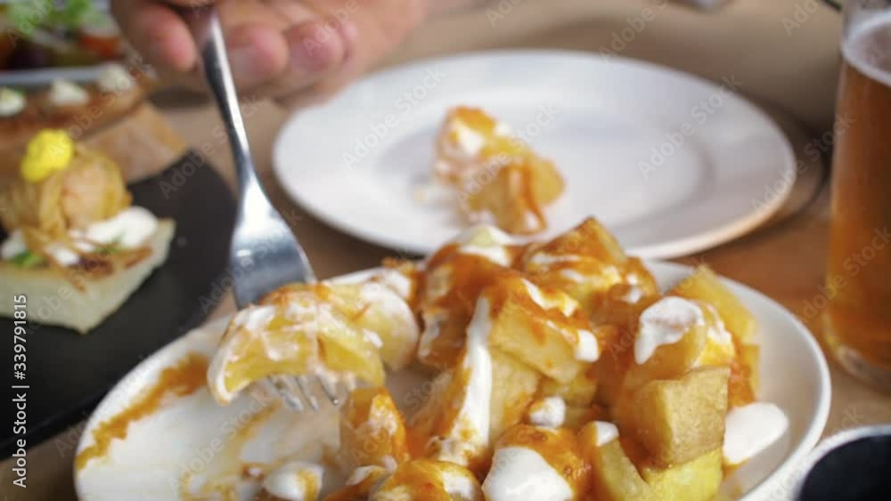 close up of Spanish potatoes patatas bravas for tapas with tomato and spicy sauce close up of Spanish potatoes patatas bravas for tapas with tomato and spicy sauce