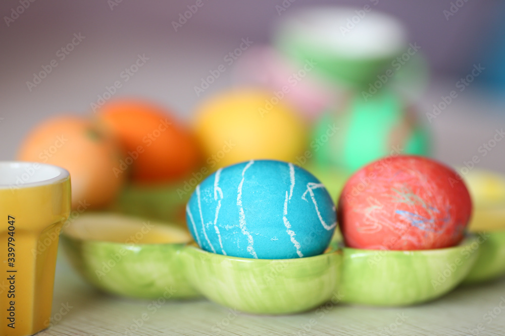 multi-colored easter eggs lie on a green dish multi-colored easter eggs lie on a green dish