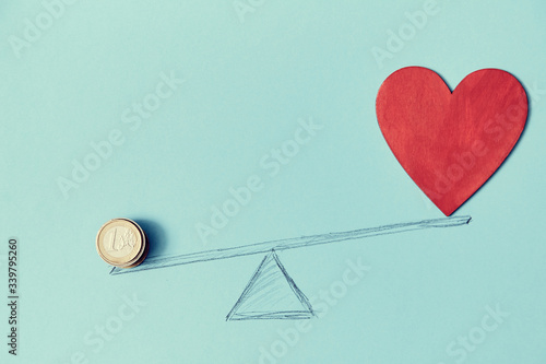 Love vs money mockup template. Blank red heart, coins on scales, copy space. Price of love. Isolated on blue background