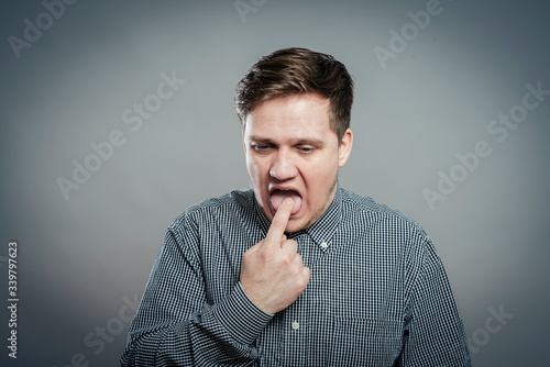 young man with finger in mouth © aeroking