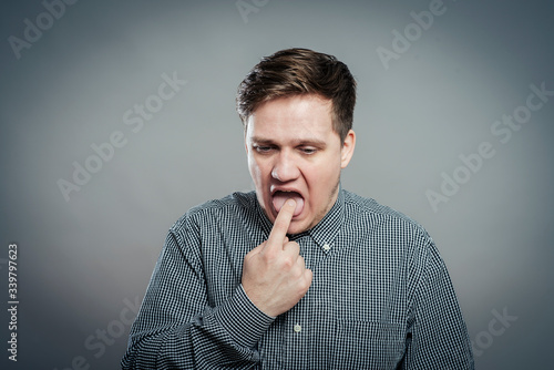 young man with finger in mouth