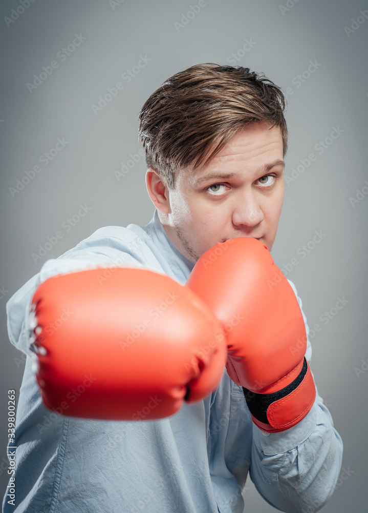 Portrait of young man in red boxing gloves fighting Portrait of young man in red boxing gloves fighting