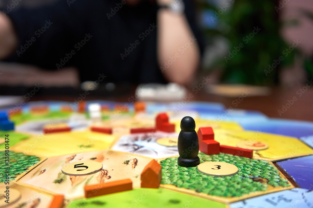 Fototapeta premium Family is playing board game on the table. 