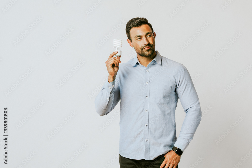 Man holding a light bulb Man holding a light bulb