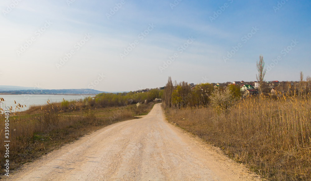 Country road near a lake in early spring