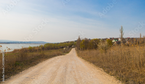 Country road near a lake in early spring