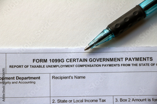 Closeup top of Form 1099G with pen