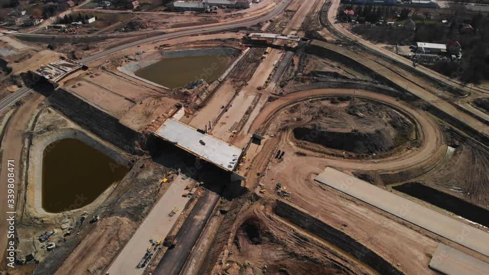 Aerial backwards fly over the large scale highway intersection construction project Aerial backwards fly over the large scale highway intersection construction project