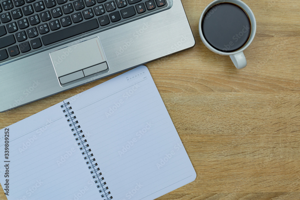 Laptop computer or notebook, note and cup of coffee on working table with copy space top view. Laptop computer or notebook, note and cup of coffee on working table with copy space top view.