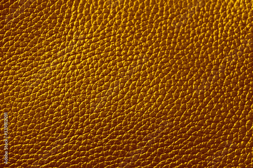 The texture of genuine leather. Brown background.