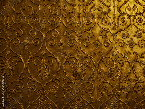 Old golden ornament on the wall