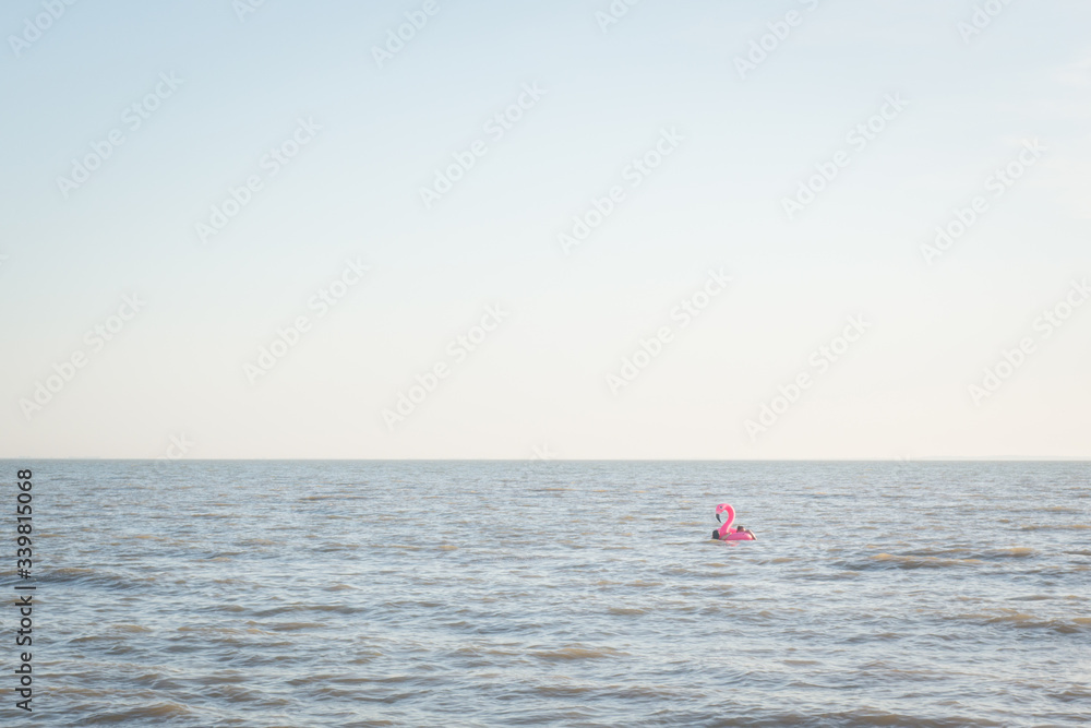 une bouée flamant rose sur la mer