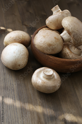 Champignon mushrooms in wood bowl