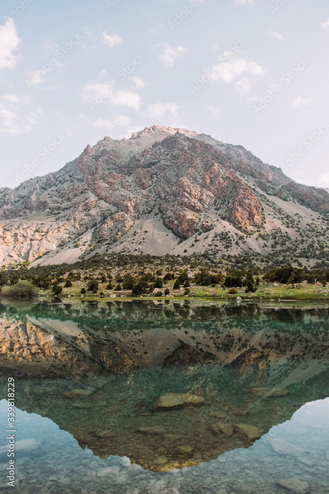 Tajikistan. Fann mountains. Summer. Beautiful mountain landscape. A large mountain is reflected in a mountain lake. Blue and green tones photos
