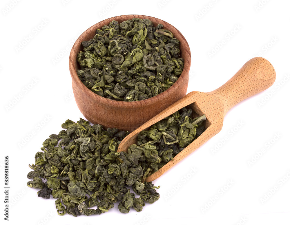 Dried green tea in a wooden bowl, with a scoop delicious, natural Dried green tea in a wooden bowl, with a scoop delicious, natural