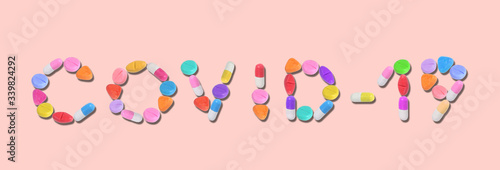 miniature blue drug model arrange in word (covid - 19) on pastel background