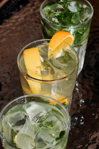 Citrus mojito made from lime and orange. Fresh summer drinks with ice.